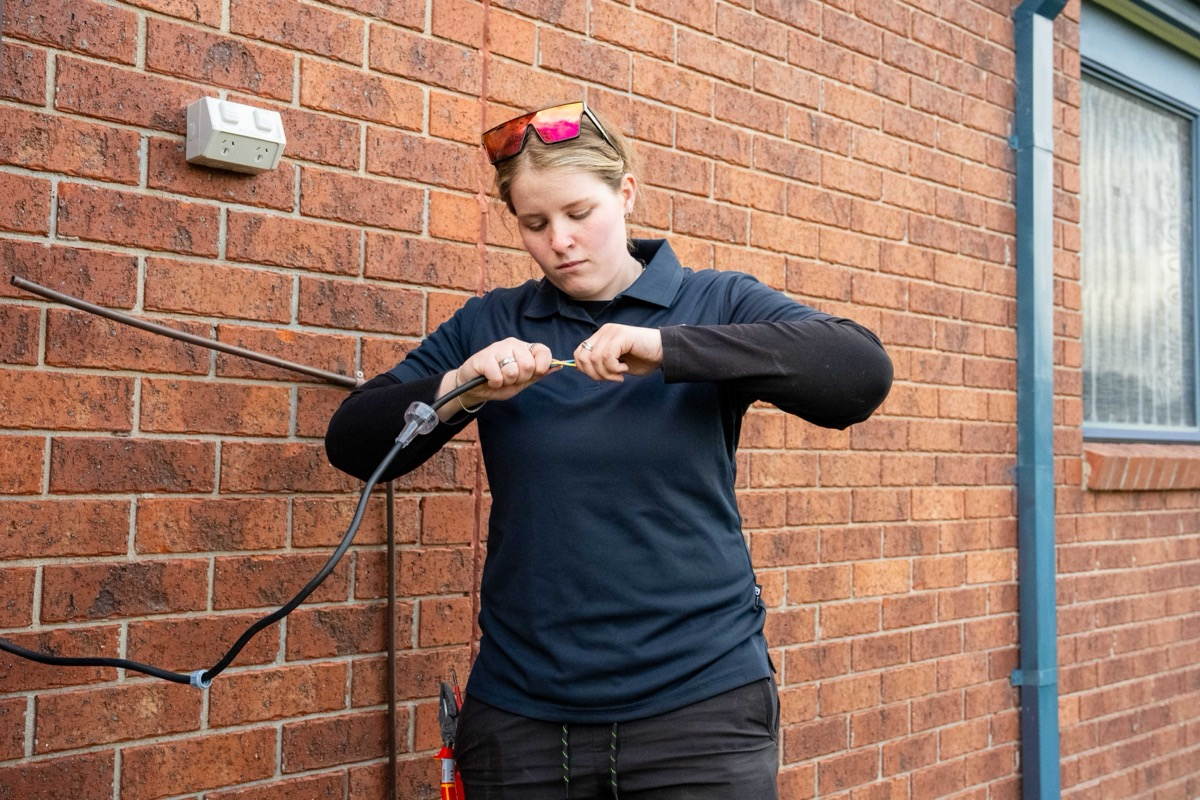 Goldsure electrician wiring a hot water heat pump circuit